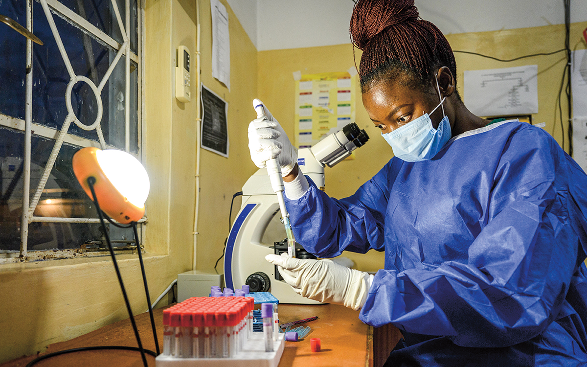 Lab technician working by light of solar lamp
