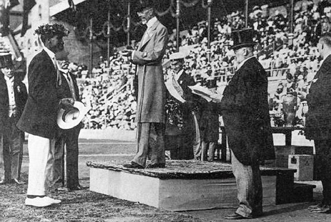 Enlargeable black & white photo of Kahanamoku receiving a gold medal at the Olympics