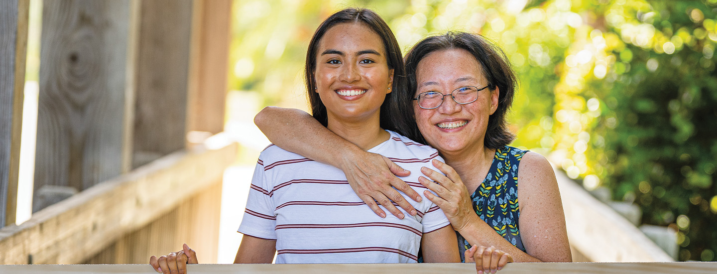 Photo of a mom and daughter posing together for a photo