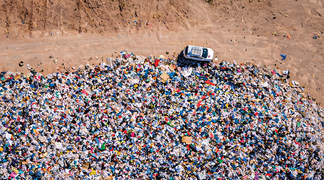 Bird&apos;s eye photo of a huge dump filled with thrown away clothes