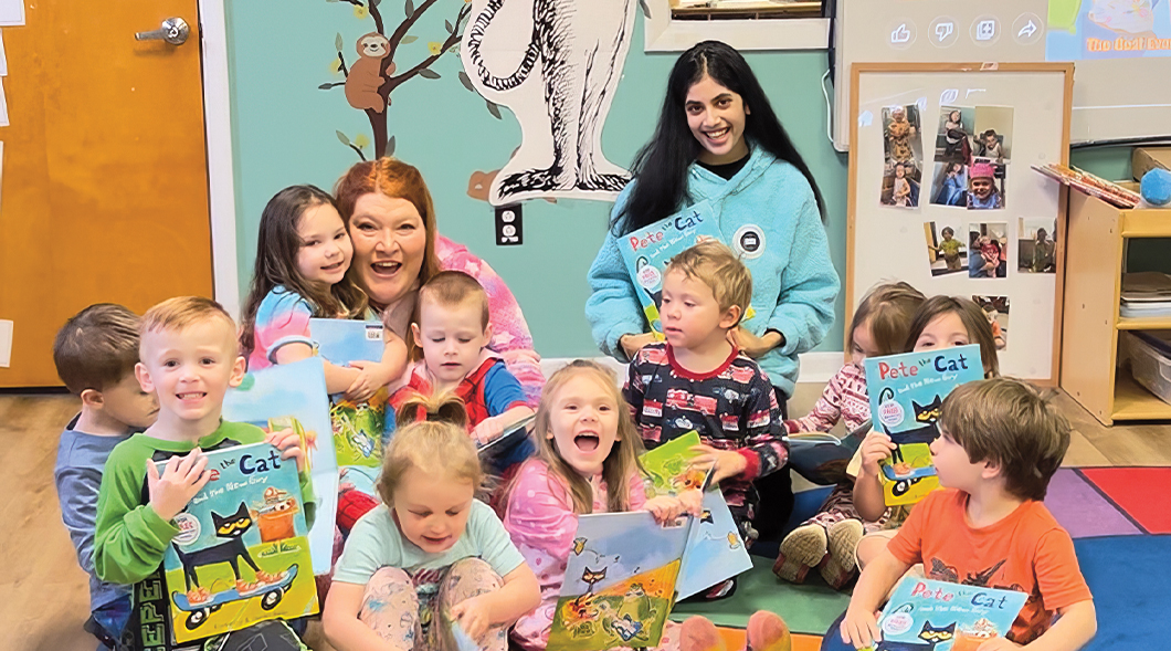 Photo of teachers and students in classroom posing with Pete the Cat books