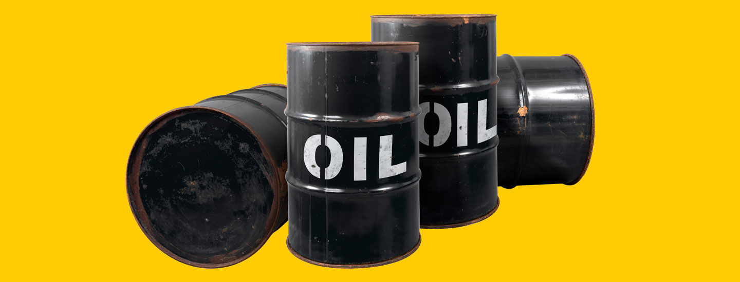 Three black metal oil barrels labeled Oil, one on its side against a yellow background