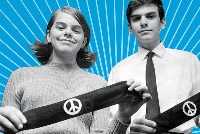 Teens holding Vietnam war protest arm bands